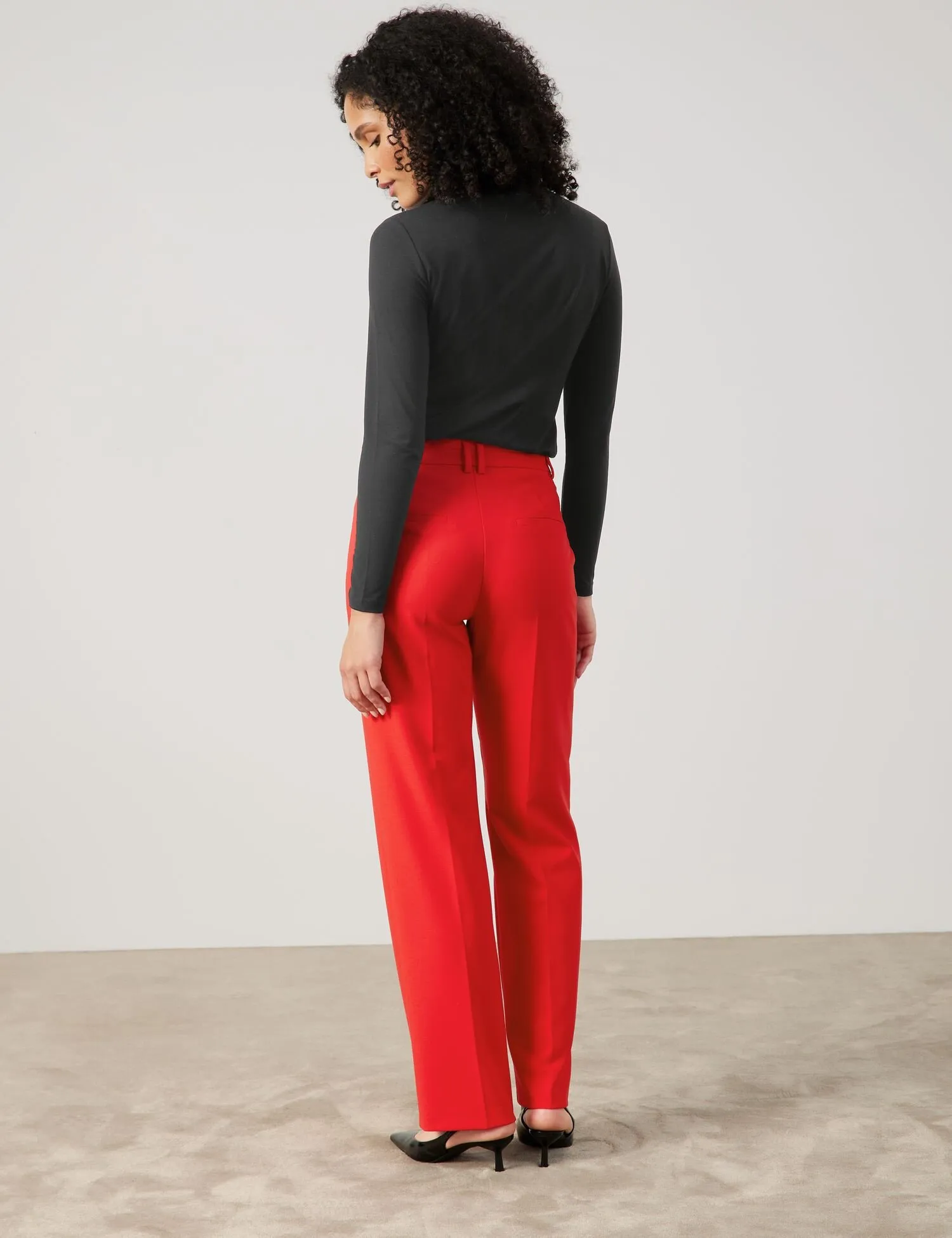 Flowing trousers with pressed pleats